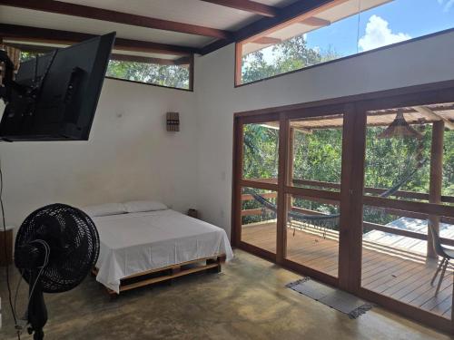 イタカレにあるRecanto da Luzのベッドと薄型テレビのある寝室