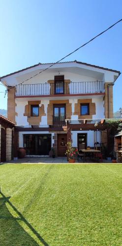 a large house with a lawn in front of it at Casa Melida in Castro-Urdiales