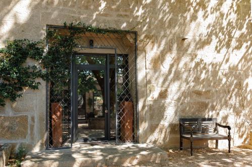 an entrance to a building with a door and a bench at Quinta de São Francisco Houses in Viseu