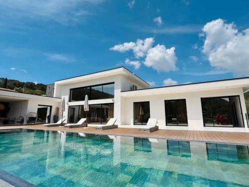 a large swimming pool in front of a house at California Baïa Bandol Villa in Bandol