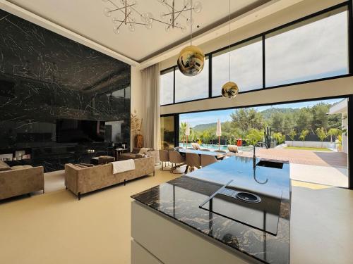 a kitchen and living room with a large window at California Baïa Bandol Villa in Bandol