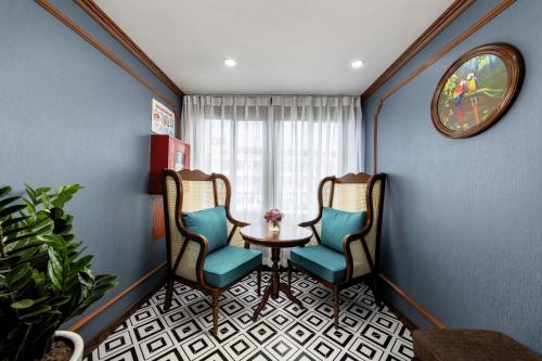 a room with two chairs and a table and a window at Verdure Lotus Grandeur Cruise on Ha Long Bay in Ha Long