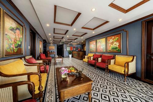 a living room with couches and a table at Verdure Lotus Grandeur Cruise on Ha Long Bay in Ha Long
