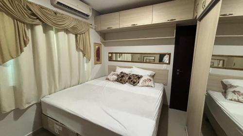 a small bedroom with two beds in a room at Home furnished in condominium in Macapá