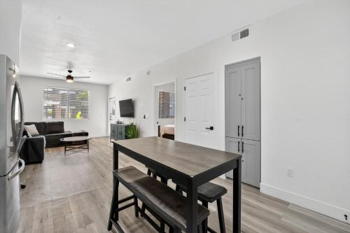 a kitchen and living room with a table and a couch at Chic 1BR at Westgate Pool, Gym & Stadium Fun apts in Shamrock Mobile Home Park
