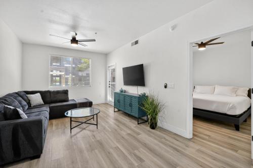a living room with a couch and a bed at Chic 1BR at Westgate Pool, Gym & Stadium Fun apts in Shamrock Mobile Home Park