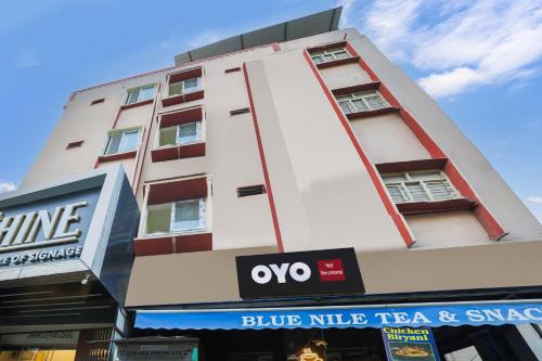 a tall white building with a blue little taco and synergy sign at SPOT ON SR CONTINENTAL in Hyderabad