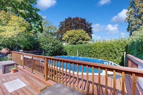 a wooden deck with a swimming pool on top of it at Multnomah Village Hideaway in Portland