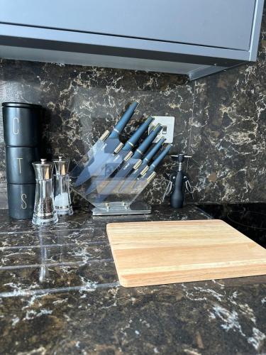 a kitchen counter with a cutting board and some knives at Cornwall - The Duke and Duchess in London