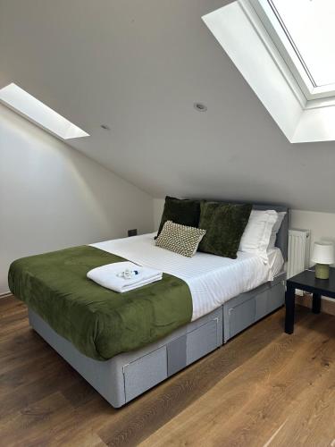 a bedroom with a large bed with white sheets and pillows at Cornwall - The Duke and Duchess in London