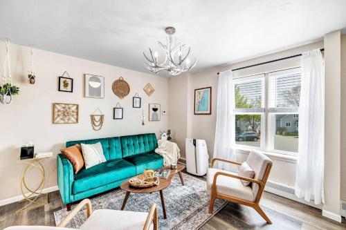 a living room with a green couch and a table at Across The Street From Von Stiehl-newly Renovated! in Algoma