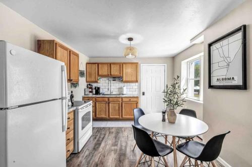 a kitchen with a white refrigerator and a table and chairs at Across The Street From Von Stiehl-newly Renovated! in Algoma