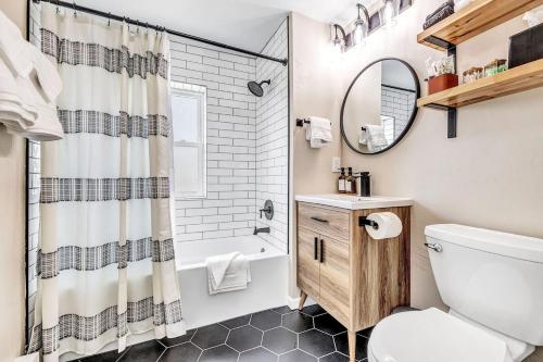 a bathroom with a sink toilet and a mirror at Across The Street From Von Stiehl-newly Renovated! in Algoma
