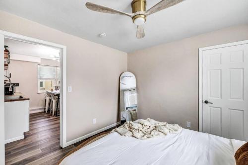 a bedroom with a bed with a ceiling fan and a mirror at Across The Street From Von Stiehl-newly Renovated! in Algoma