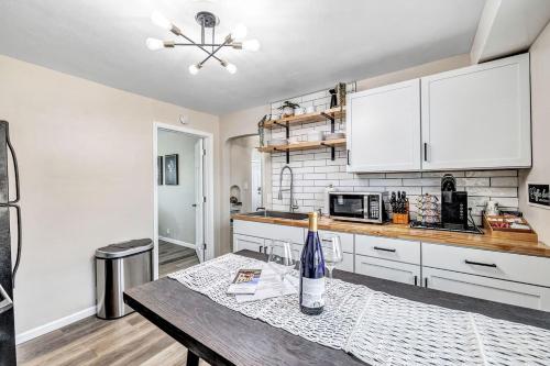 a kitchen with white cabinets and a wooden table at Across The Street From Von Stiehl-newly Renovated! in Algoma