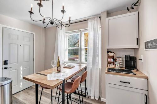 a kitchen with a table and chairs and a kitchen with a window at Across The Street From Von Stiehl-newly Renovated! in Algoma