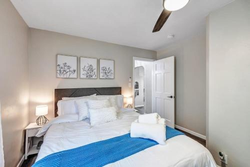 a bedroom with a large white bed with a blue blanket at Across The Street From Von Stiehl-newly Renovated! in Algoma