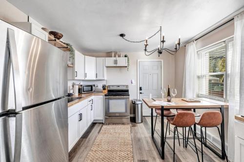 a kitchen with a refrigerator and a table with stools at Across The Street From Von Stiehl-newly Renovated! in Algoma