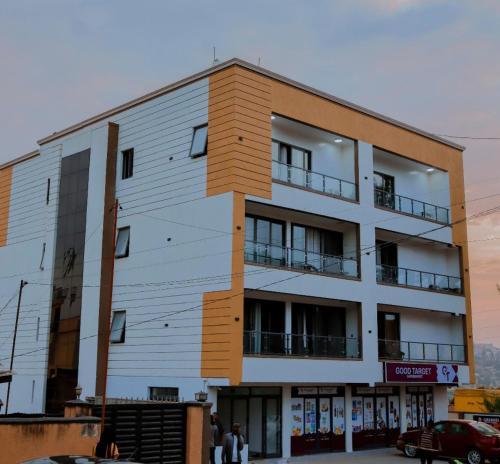 a building with people walking in front of it at Kigali Bliss Apartment in Kigali