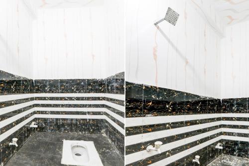 a bathroom with black and white stairs and a toilet at Hotel O BRS Dream in Hasanganj