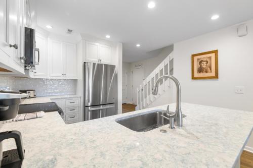 a kitchen with a sink and a refrigerator at Mariner's Walk 5F - Ocean View Condo! Pool! in Isle of Palms