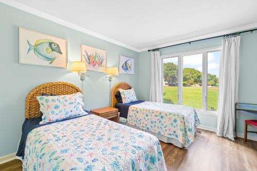a bedroom with two beds and a window at Mariner's Walk 5F - Ocean View Condo! Pool! in Isle of Palms