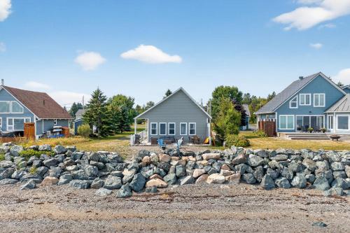 a pile of rocks in front of some houses at Little Paradis in Beresford