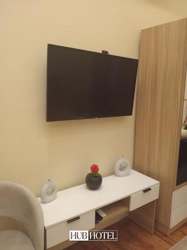 a living room with a tv on a wall at Cairo Downtown Hotel in Cairo