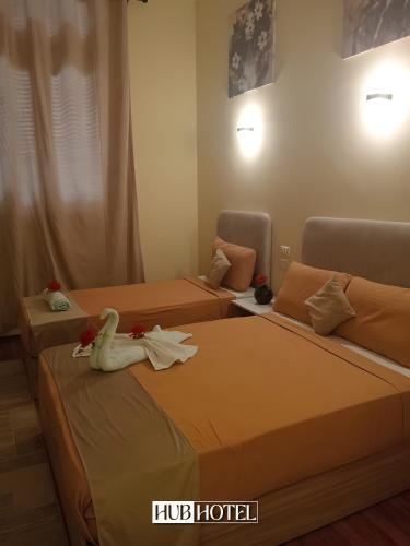 two beds in a hotel room with a stuffed animal on them at Cairo Downtown Hotel in Cairo