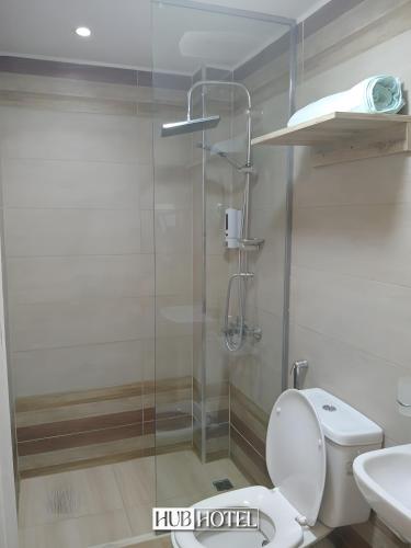 a bathroom with a toilet and a glass shower at Cairo Downtown Hotel in Cairo