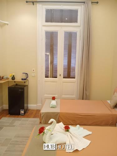 a hotel room with two beds and two towels at Cairo Downtown Hotel in Cairo