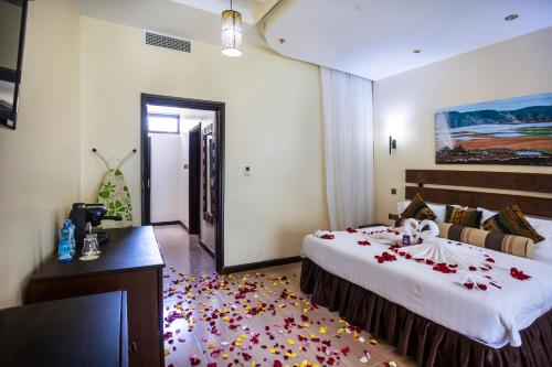 a bedroom with a large bed with flowers on the floor at Lake Bogoria Spa Resort in Marigat