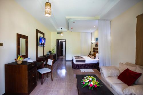 a living room with a couch and a bed at Lake Bogoria Spa Resort in Marigat