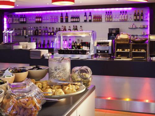 a restaurant with a counter with food and drinks at ibis Liverpool Centre Albert Dock – Liverpool One in Liverpool