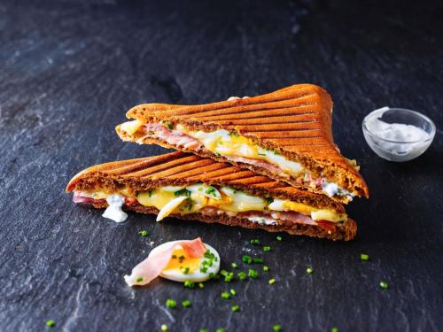 a sandwich cut in half on a table at ibis London Wembley in London