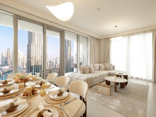 a living room with a couch and a table at Forte Suites by Prestige Nest in Dubai