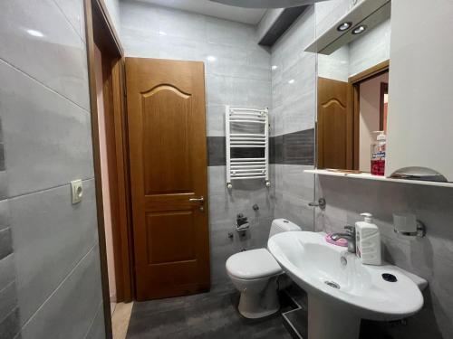 a bathroom with a sink and a toilet and a mirror at Ete in Tbilisi City