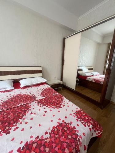 a bedroom with a bed covered in red roses at Ete in Tbilisi City