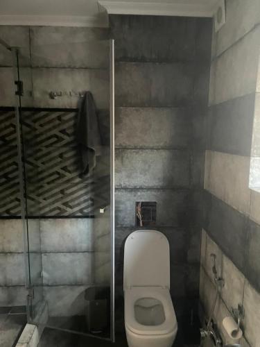 a bathroom with a toilet and a glass shower at Номера in Dobrovelychkivka