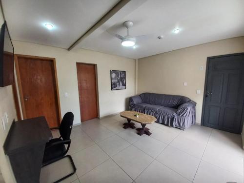a living room with a couch and a table at Flat - Apartium Palacete Victória in Sao Paulo