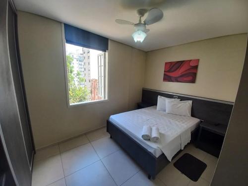 a bedroom with a bed with two towels on it at Flat - Apartium Palacete Victória in Sao Paulo
