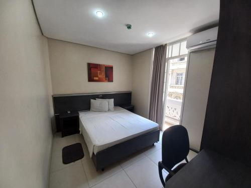 a small bedroom with a bed and a window at Flat - Apartium Palacete Victória in Sao Paulo