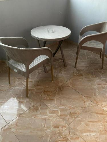 a table and two chairs and a table and a table at Abdin pyramids view in Cairo