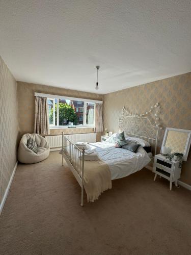 a bedroom with a bed and a window at Pebbles & Prosecco in Brighton & Hove