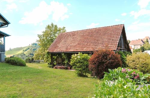 a large building with a roof on a yard at Ferienwohnungen Karin am Seggauberg in Leibnitz