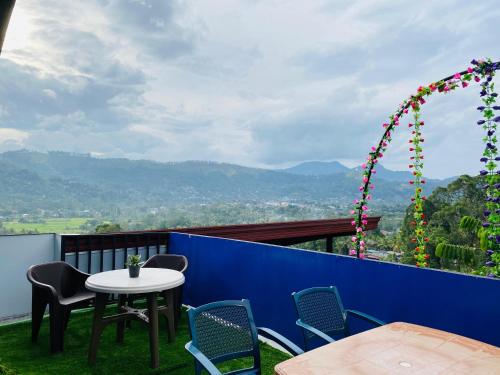 a table and chairs on a balcony with a view at TK Homes in Badulla