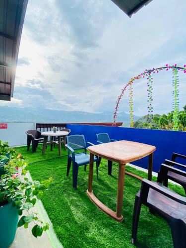a patio with tables and chairs on the grass at TK Homes in Badulla