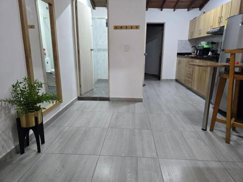 an empty room with a kitchen with wooden floors at Apartamento Guatapé Plaza in Guatapé
