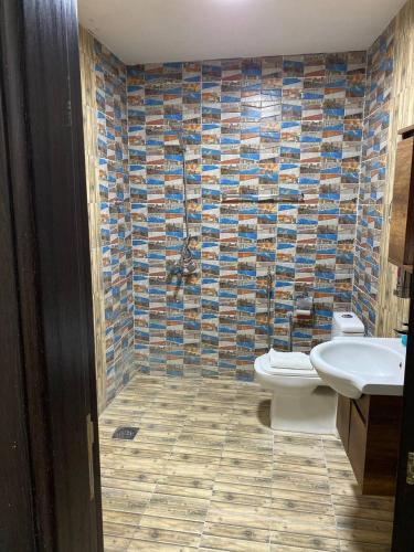 a bathroom with a toilet and a sink at Durrat Nizwa Inn in Nizwa
