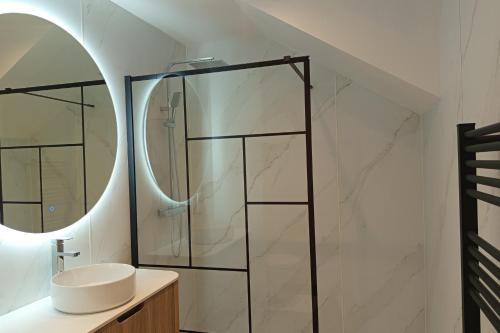 a bathroom with a sink and a mirror at New apartment with terrace in the center in Stella-Plage